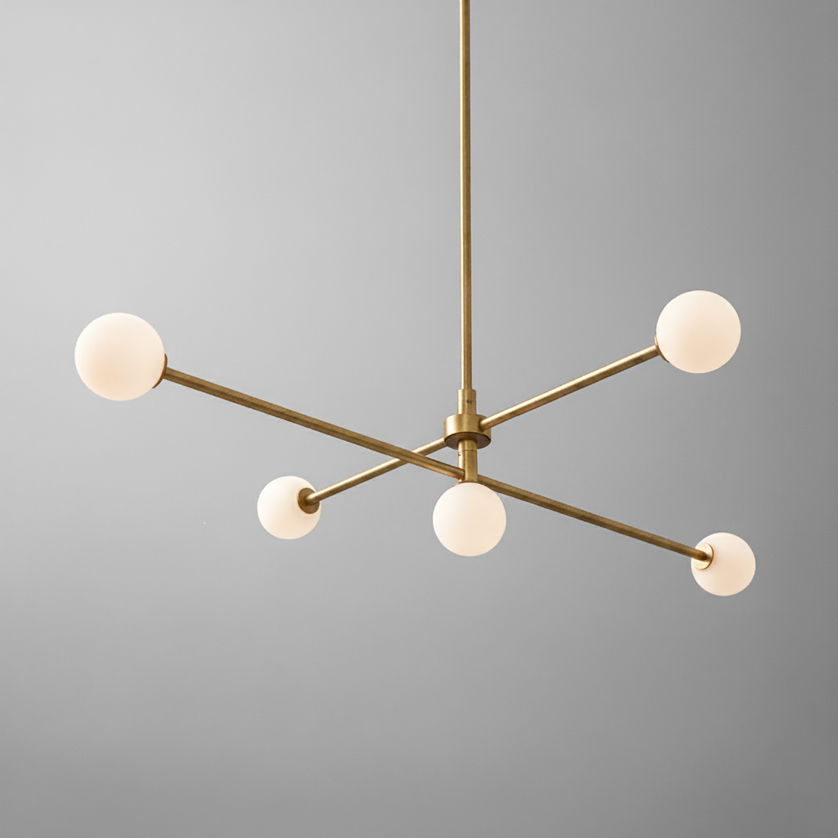 Mid-century modern brass chandelier with four white globe lights and swivel arms. - CHANDELIER MODEL NO. 4577