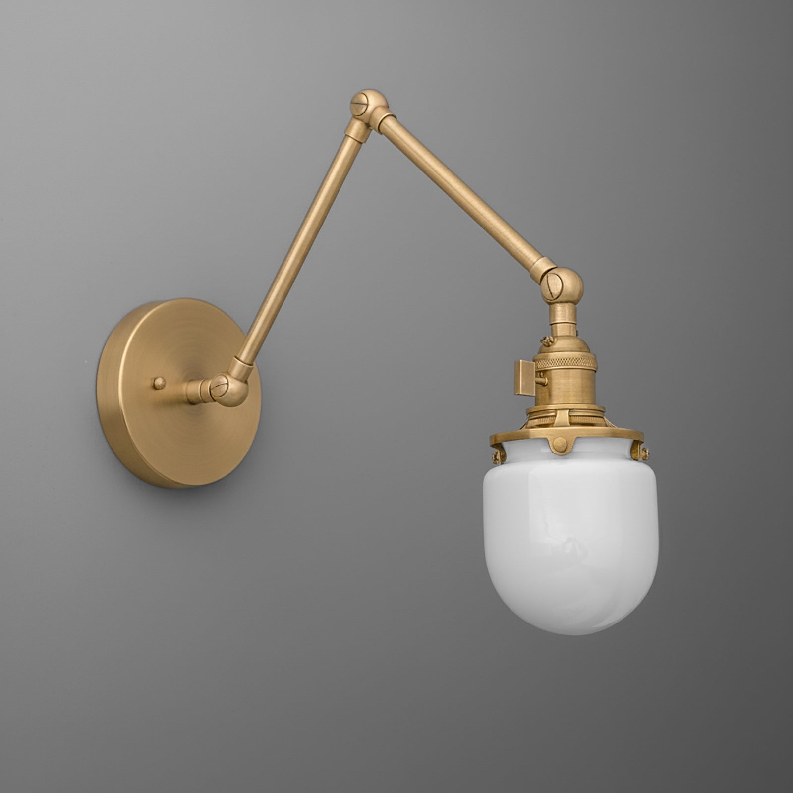 Adjustable brass wall sconce with a round base and white glass globe shade. - SCONCE MODEL NO. 7575