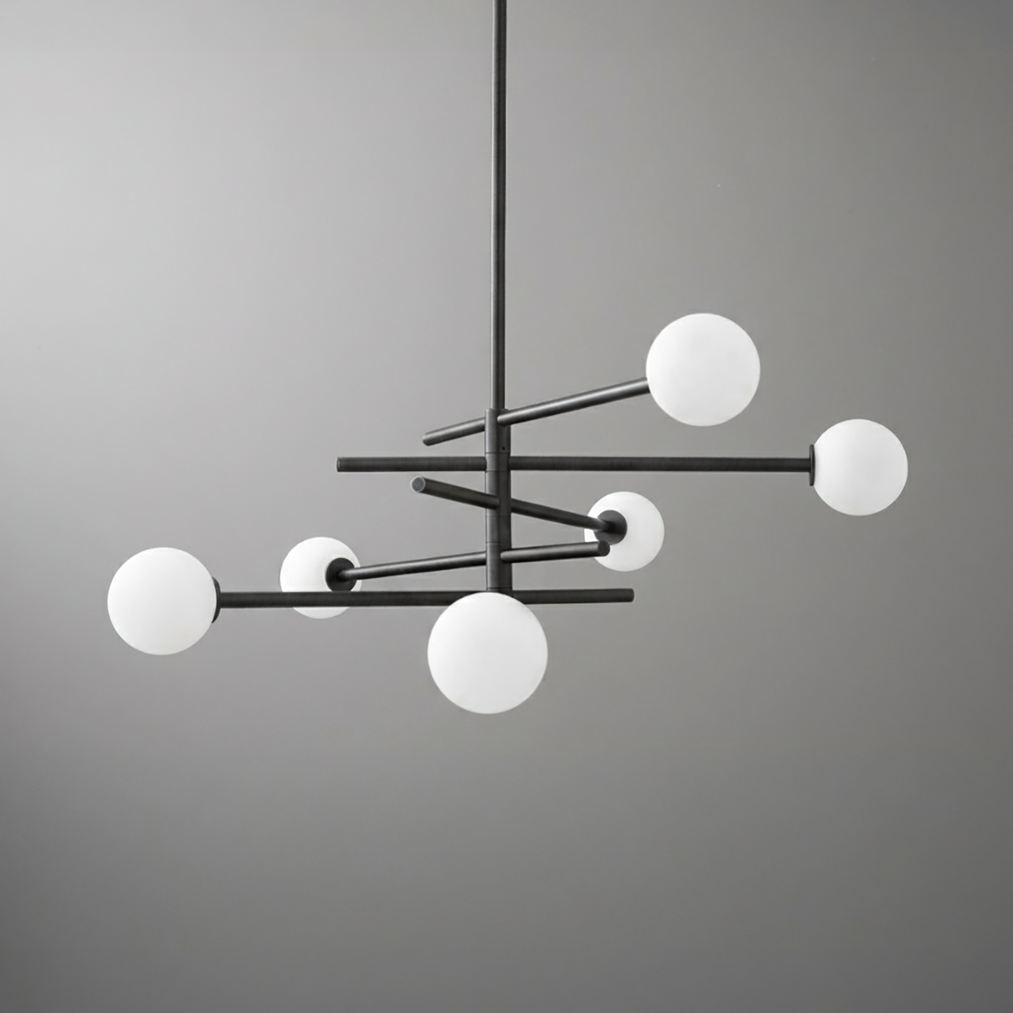 Modern black metal chandelier with six frosted white glass globes arranged asymmetrically on horizontal rods. - CHANDELIER MODEL NO. 8576