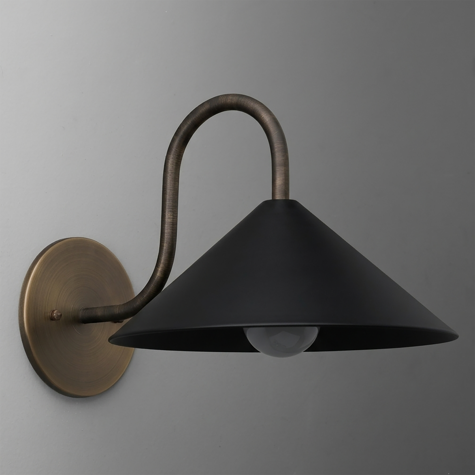 Wall-mounted sconce with curved bronze arm and wide black metal conical shade, single bulb. - SCONCE MODEL NO. 1015