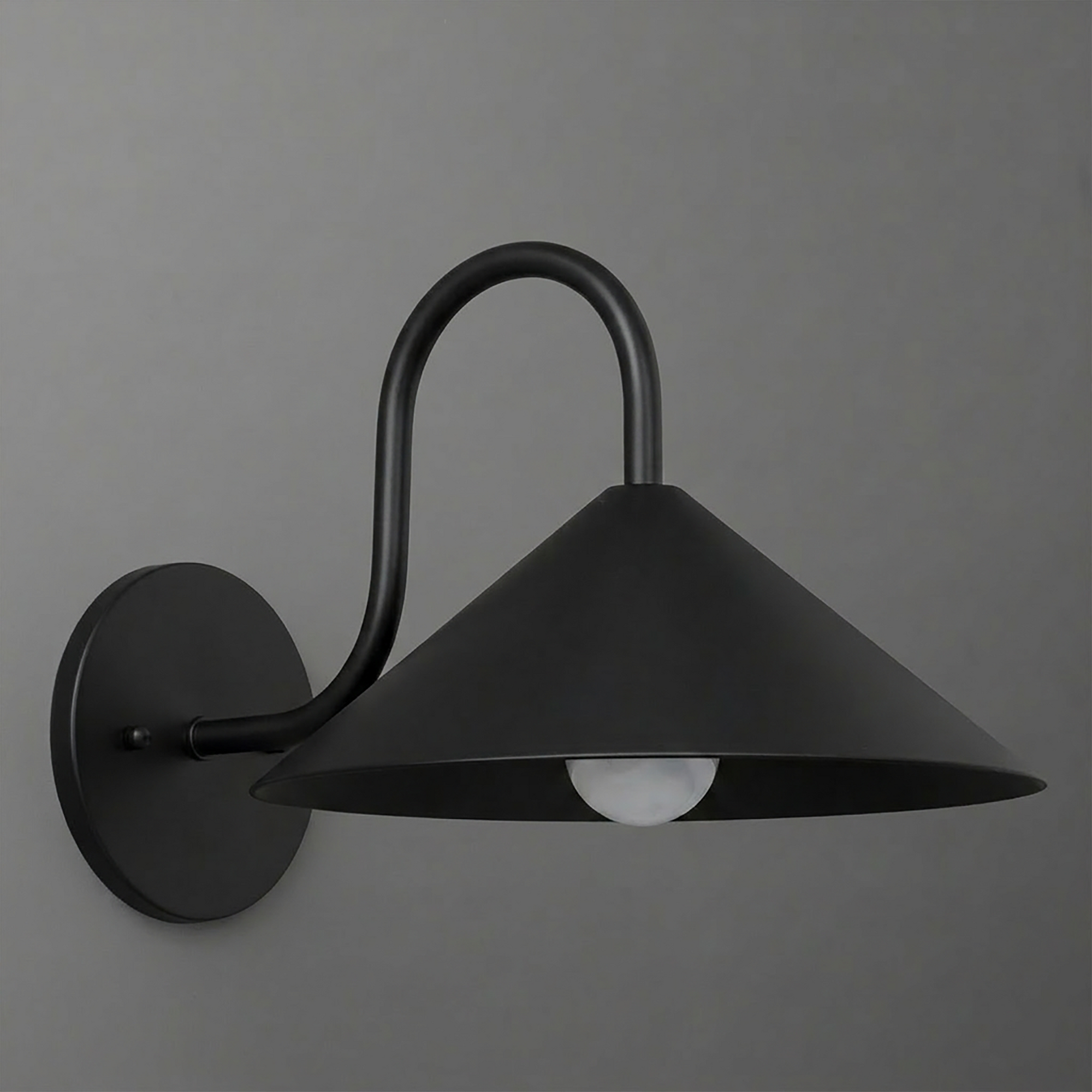 Black metal wall sconce with a wide conical shade and curved arm holding one exposed bulb. - SCONCE MODEL NO. 1015