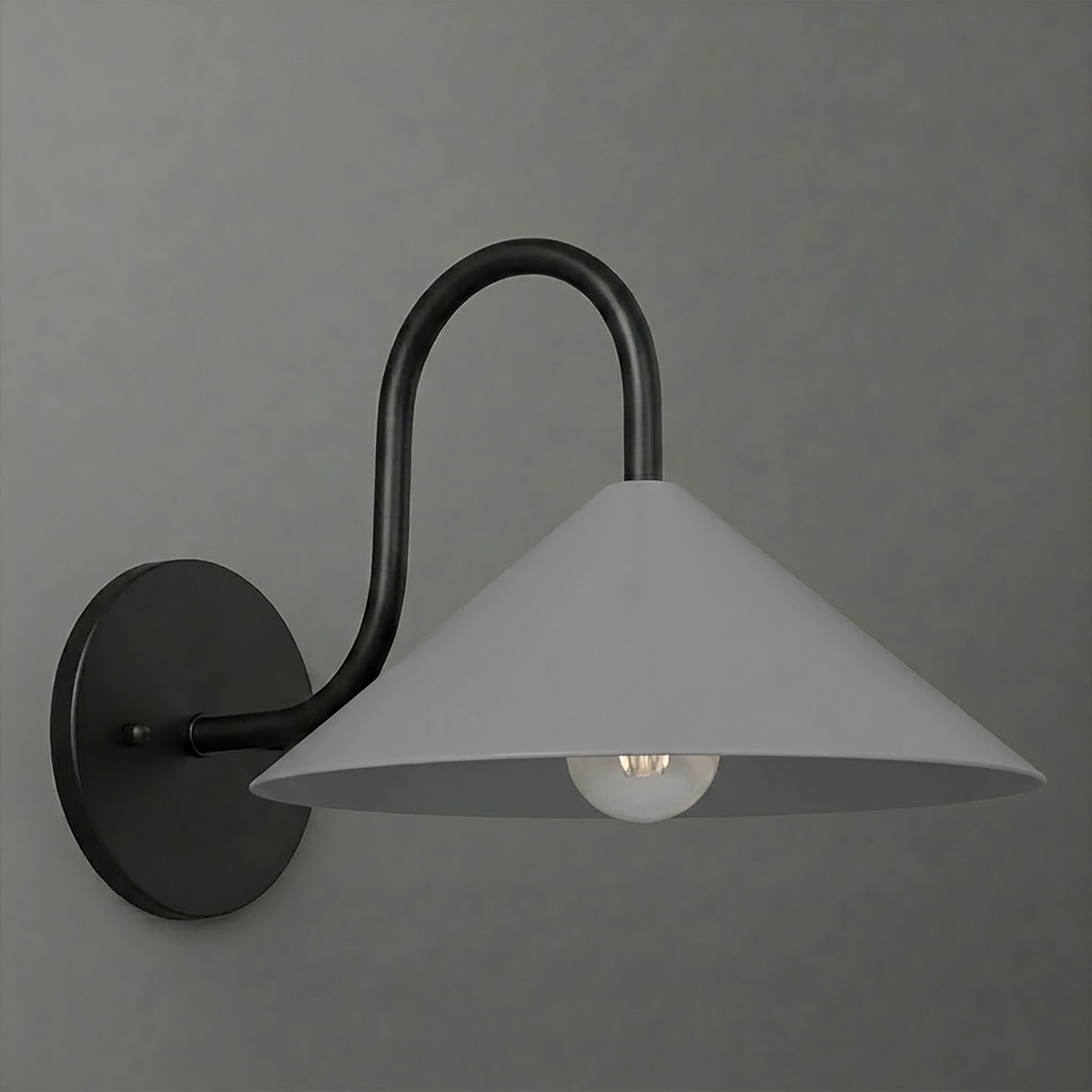Matte black metal wall sconce with a curved arm and wide conical white shade, single bulb exposed beneath. - SCONCE MODEL NO. 1015