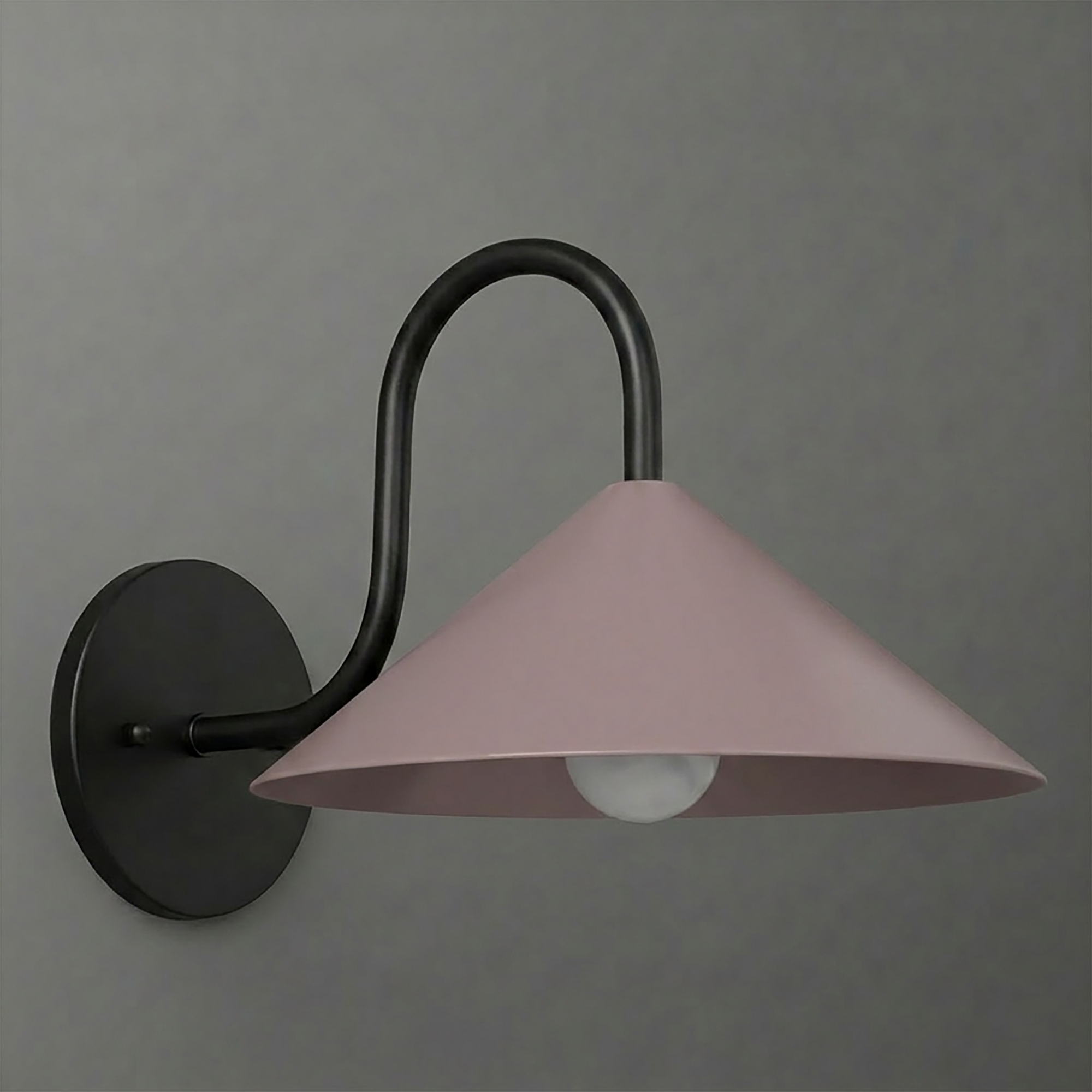 Matte black metal wall sconce with a curved arm and a wide, dusty pink conical shade covering one bulb. - SCONCE MODEL NO. 1015