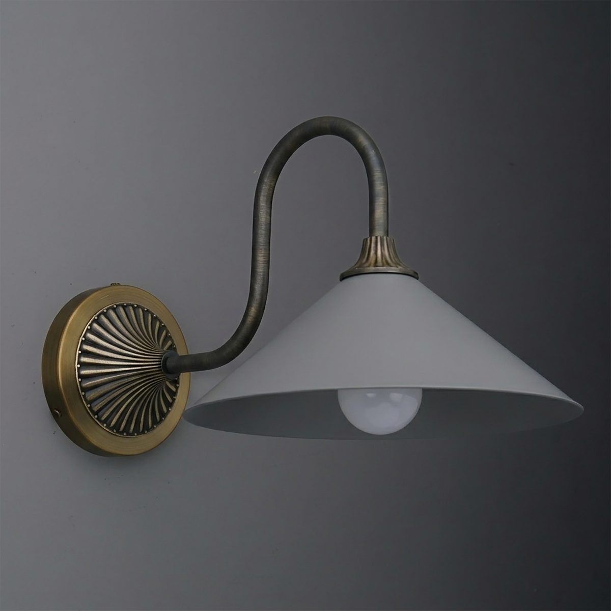 Wall sconce with aged brass circular base, curved dark metal arm, and wide white conical shade. - SCONCE MODEL NO. 1031