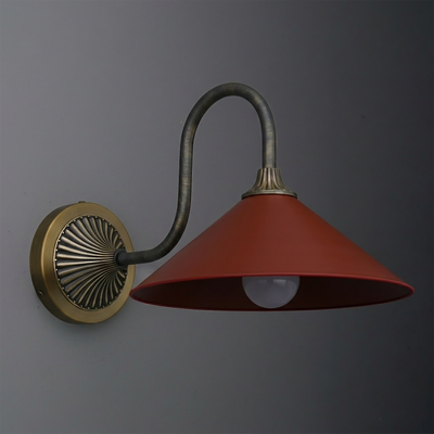 Wall-mounted sconce with a curved bronze arm, round brass base, and wide red metal shade. - SCONCE MODEL NO. 1031