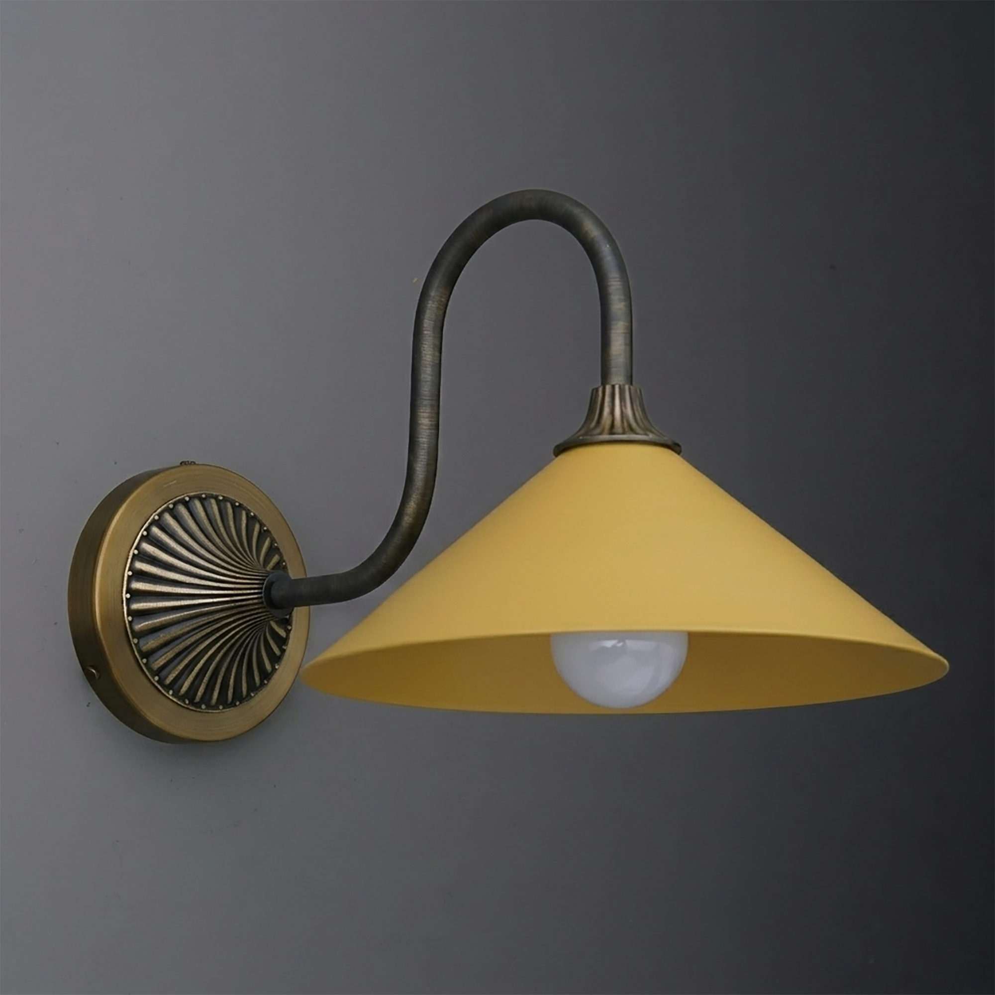 Yellow metal conical shade wall sconce with curved dark bronze arm and round decorative backplate. - SCONCE MODEL NO. 1031
