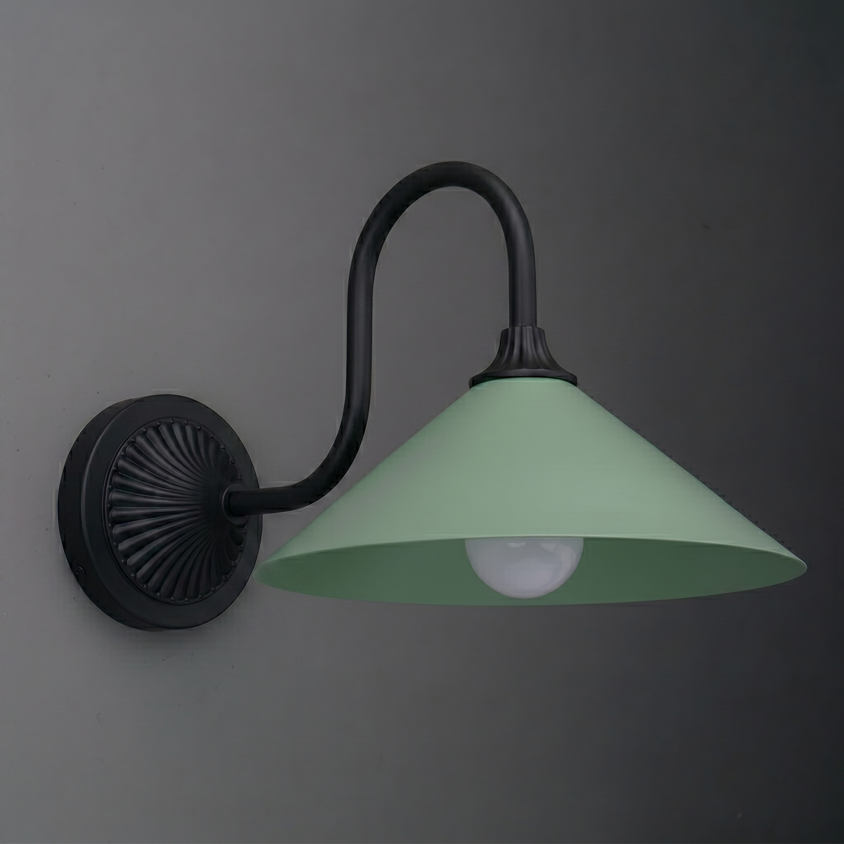 Wall-mounted sconce with matte black curved arm and circular base, featuring a wide green metal shade and exposed bulb. - SCONCE MODEL NO. 1031