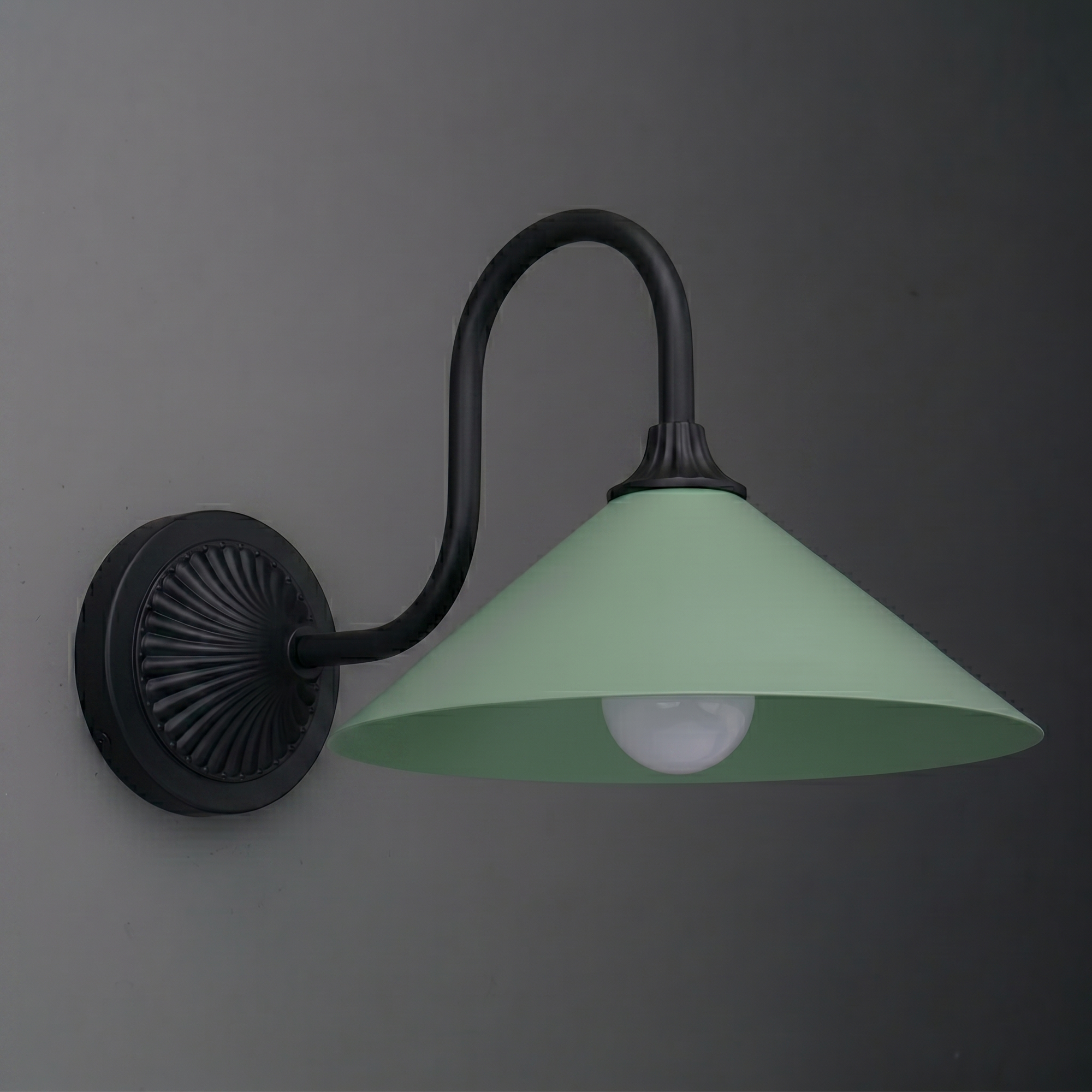 Wall-mounted sconce with matte black curved arm and circular base, featuring a wide green metal shade and exposed bulb. - SCONCE MODEL NO. 1031