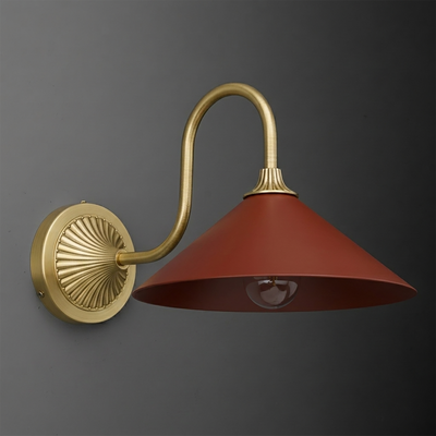 Wall sconce with a curved brass arm and round backplate, featuring a wide conical matte red metal shade and exposed bulb. - SCONCE MODEL NO. 1031