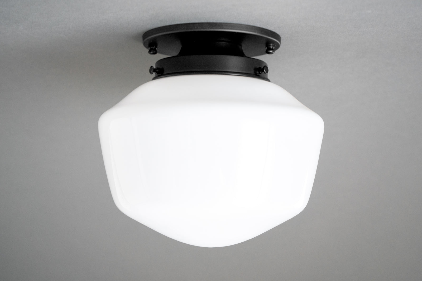 Flush mount ceiling light in Black with a round canopy holding an opal glass schoolhouse shade. - CEILING LIGHT MODEL NO. 7149
