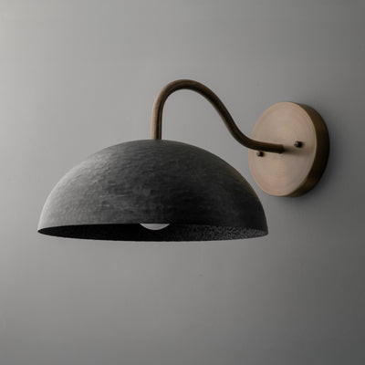 Wall sconce with a dark textured dome shade and curved metal arm mounted on a round base. - SCONCE MODEL NO. 9874