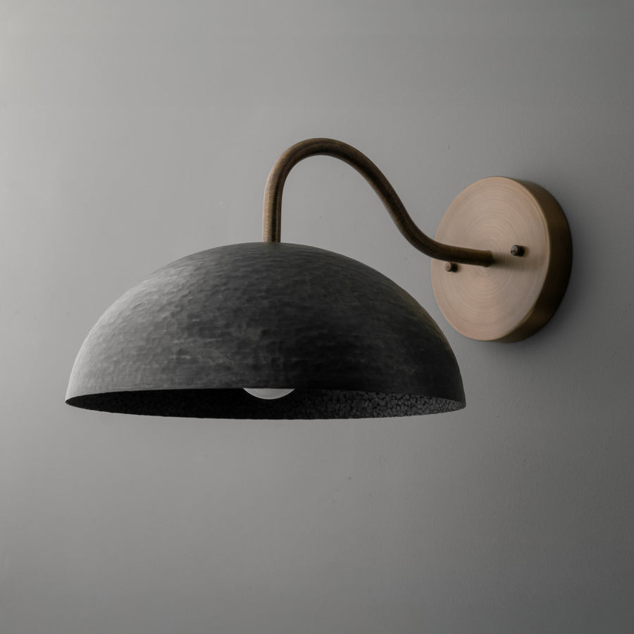 Wall sconce with a dark textured dome shade and curved metal arm mounted on a round base. - SCONCE MODEL NO. 9874