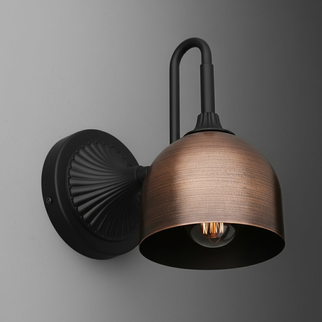Wall-mounted sconce with black metal base and curved arm, featuring a copper-toned dome shade and exposed bulb. - SCONCE MODEL NO. 3046