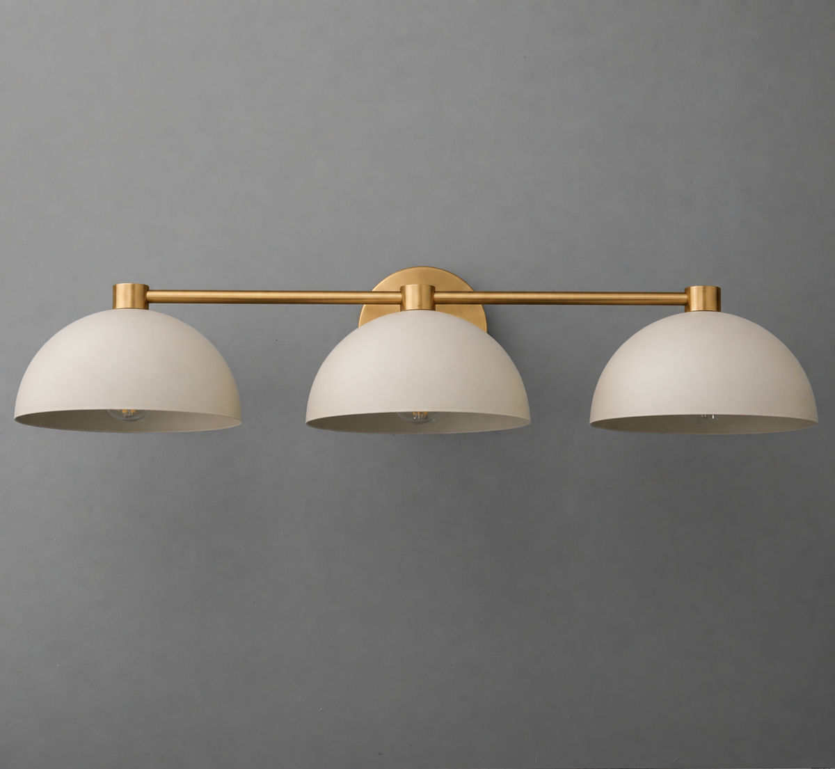 Three-light vanity fixture with matte white dome shades and brushed brass horizontal bar mount. - VANITY LIGHT MODEL NO. 1159
