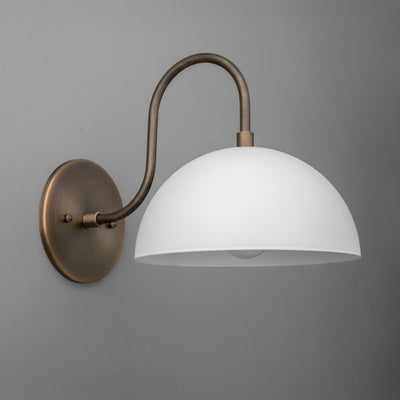 Wall-mounted sconce with a matte white dome shade and curved raw brass arm on a round brass base. - SCONCE MODEL NO. 9092