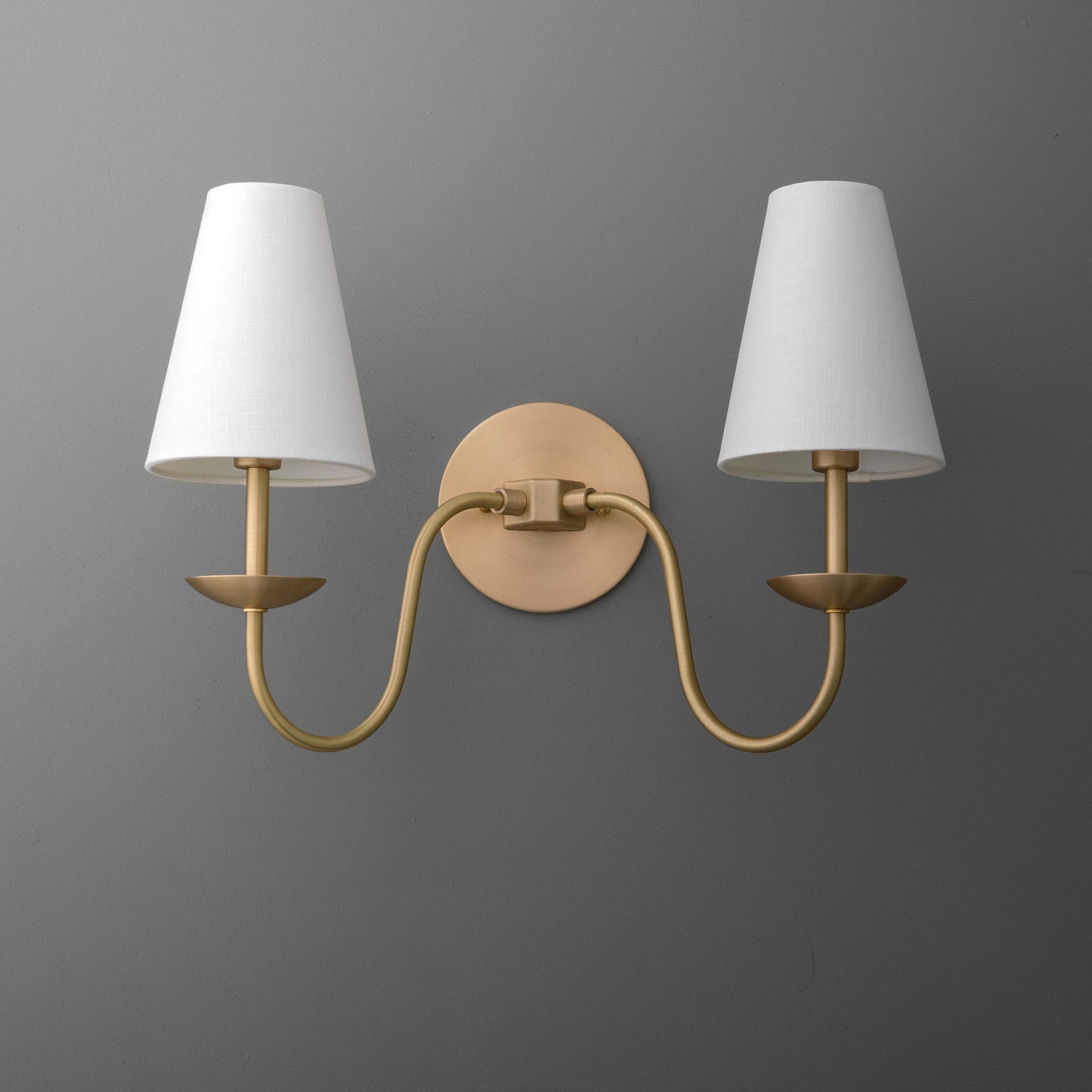 Brushed gold two-arm wall sconce with white tapered fabric shades and round backplate. - SCONCE MODEL NO. 5846