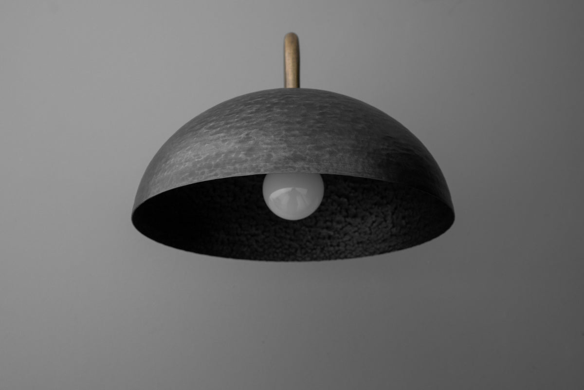 Minimalist dome-shaped black metal sconce with exposed bulb and brass stem mounting. - SCONCE MODEL NO. 9874
