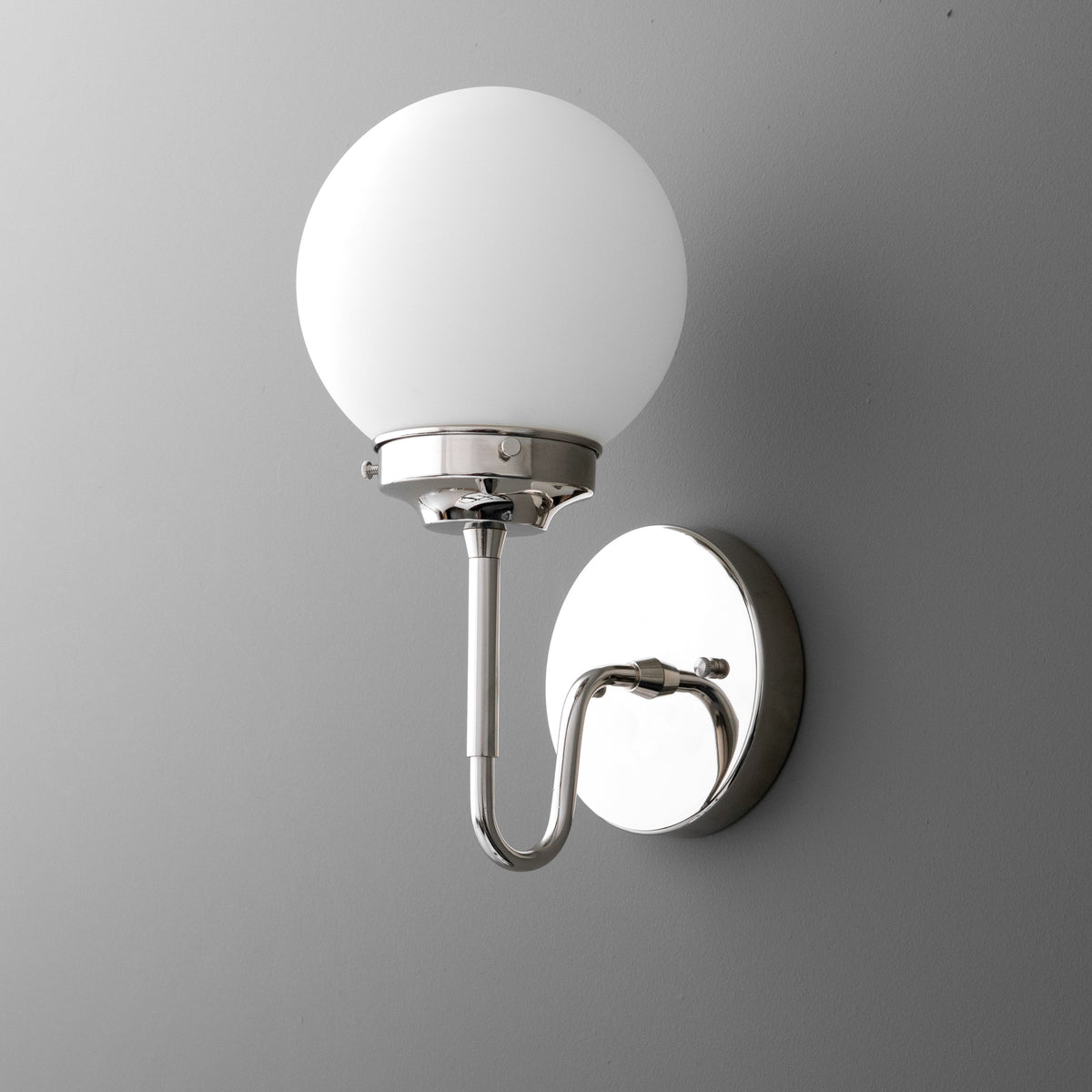 Wall-mounted single-bulb sconce with frosted white glass globe shade and polished chrome curved arm and round base. - SCONCE MODEL NO. 3690