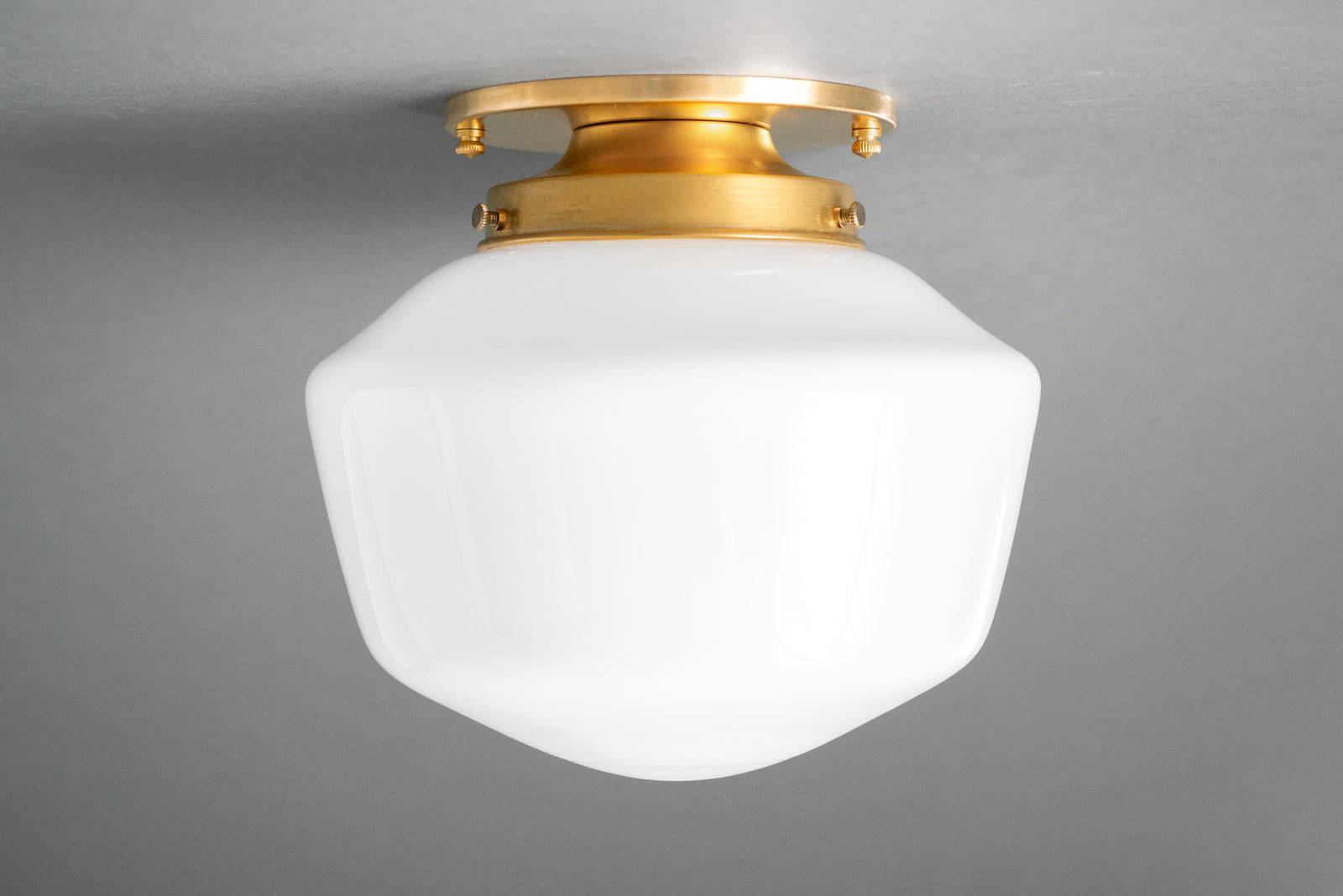 Flush mount ceiling light in Raw or Sealed Brass holding an opal glass schoolhouse shade. - CEILING LIGHT MODEL NO. 7149