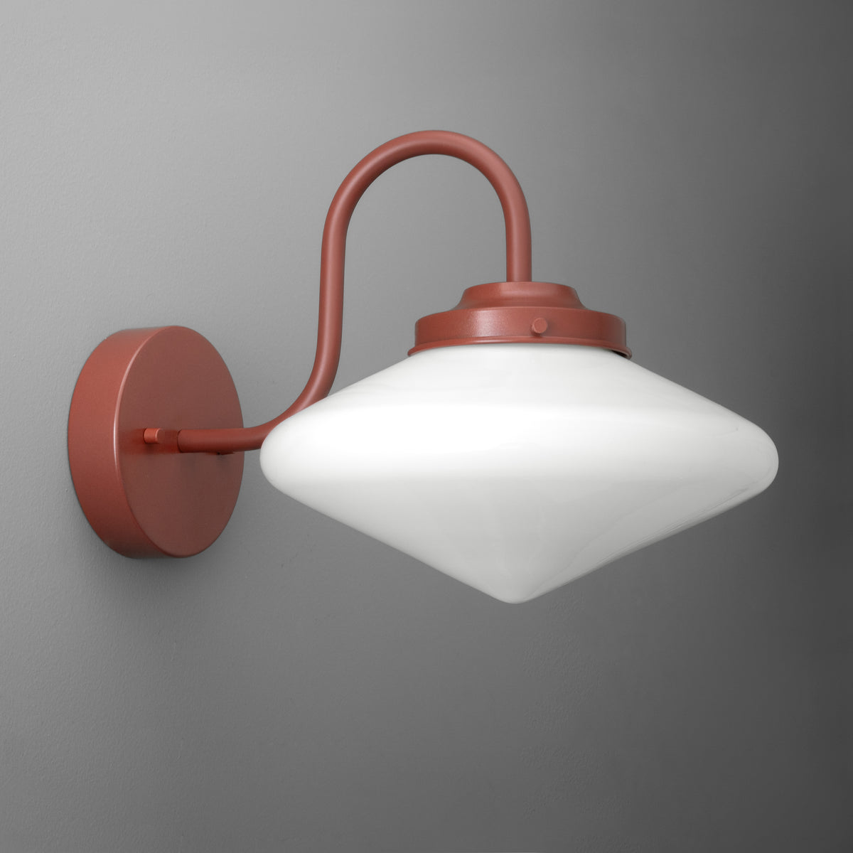 Wall-mounted sconce with rust-colored metal arm and frosted white glass shade in a pointed oval shape. - SCONCE MODEL NO. 1019