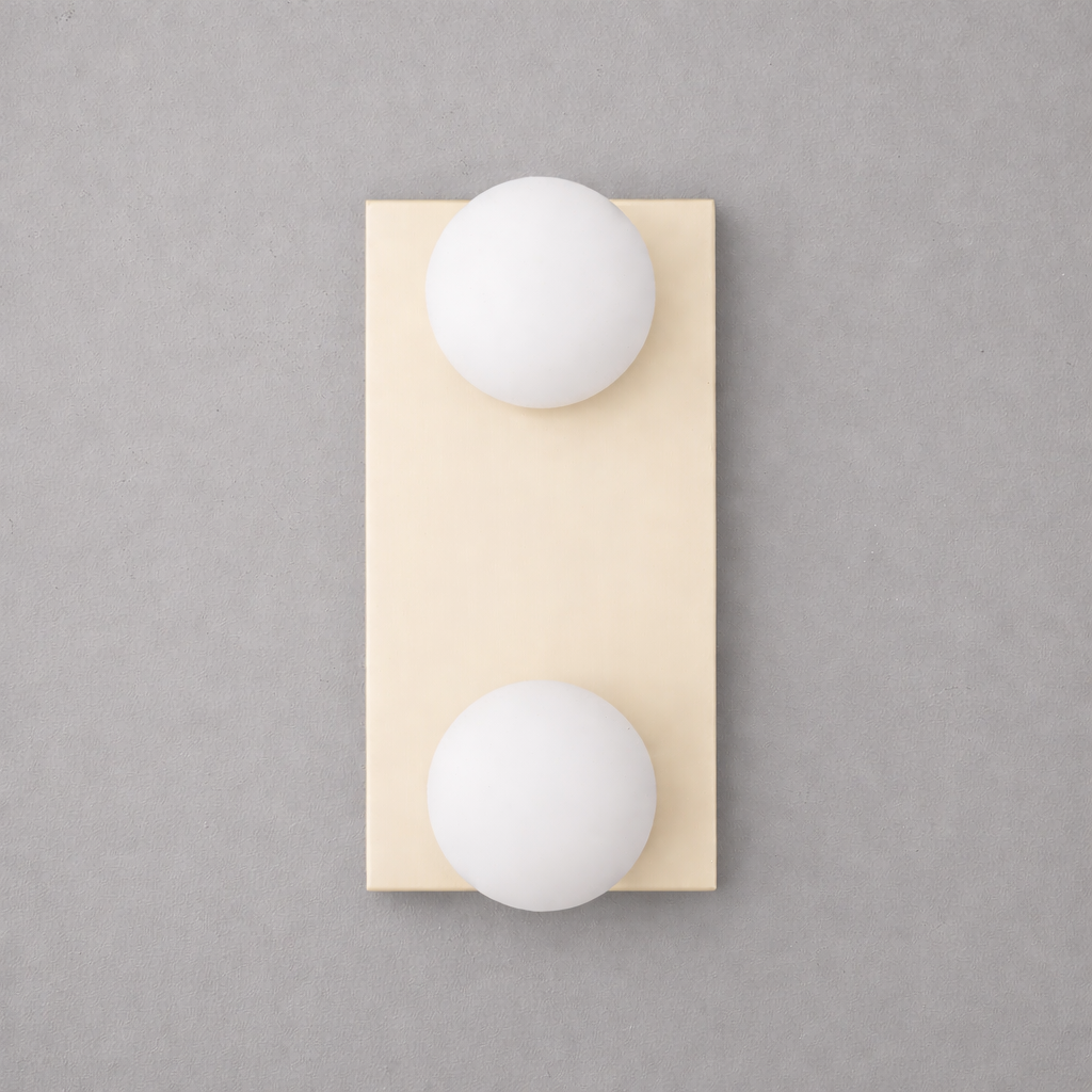Vertical rectangular brass wall sconce with two frosted white glass globe bulbs, one at top and one at bottom. - SCONCE MODEL NO. 4016