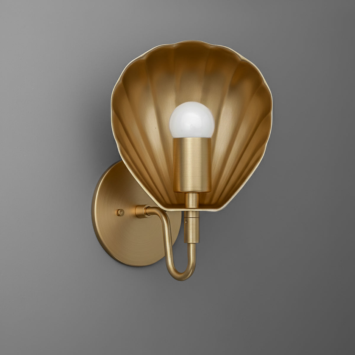 Gold metal wall sconce with scallop shell-shaped backplate and single exposed bulb. - SCONCE MODEL NO. 1086