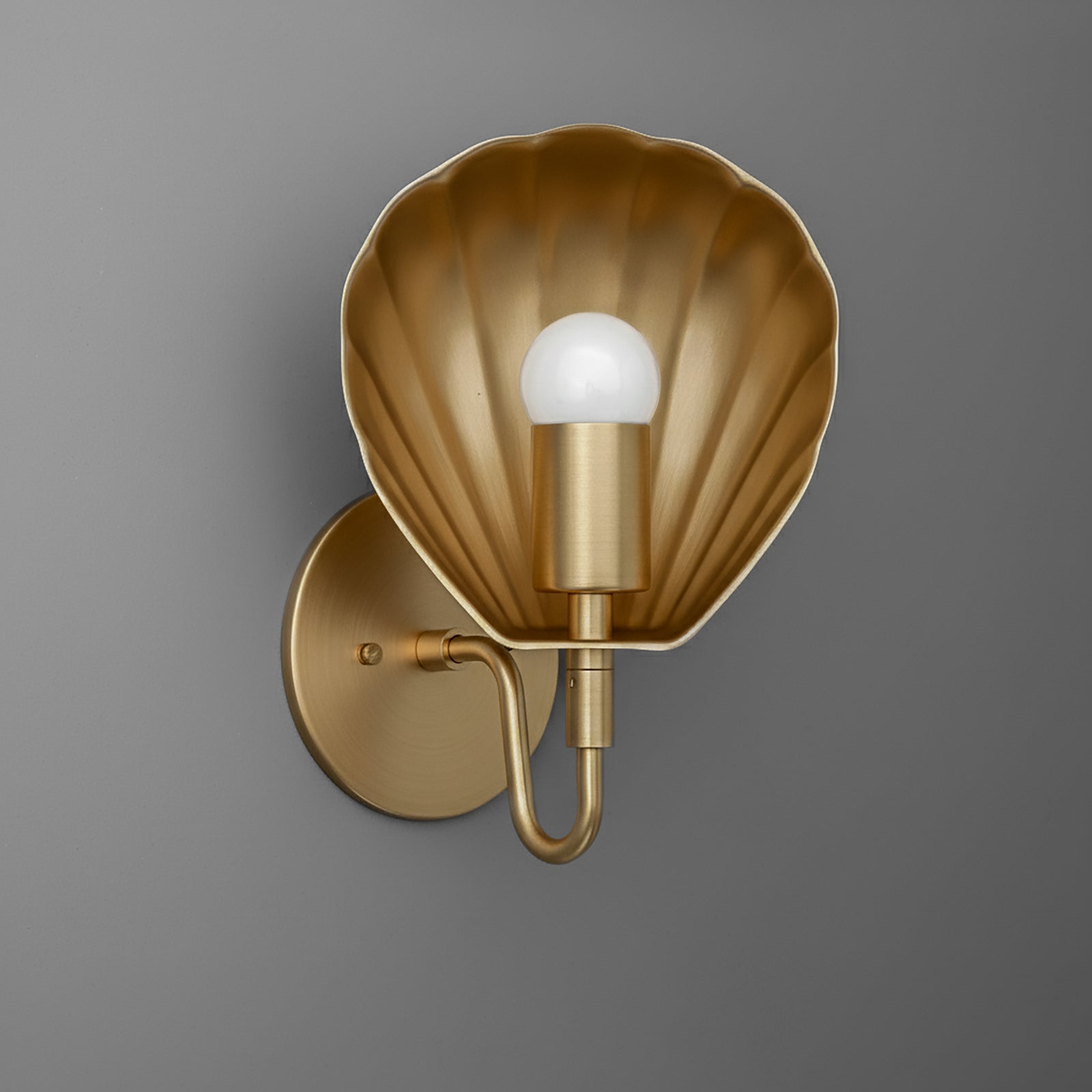 Gold metal wall sconce with scallop shell-shaped backplate and single exposed bulb. - SCONCE MODEL NO. 1086