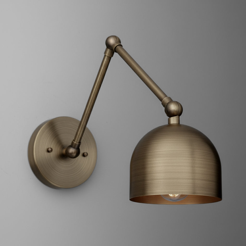 Antique brass adjustable arm wall sconce with dome-shaped metal shade and round backplate. - SCONCE MODEL NO. 5997