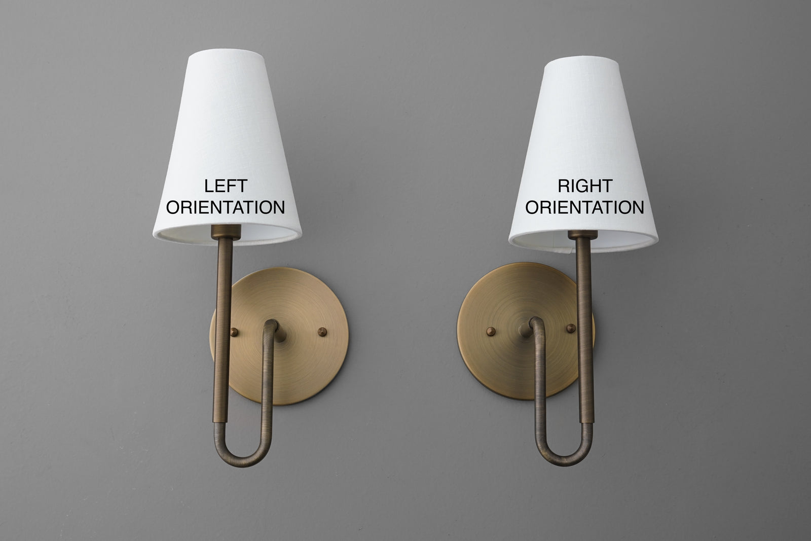 Pair of wall sconces with white conical fabric shades and brass-toned circular backplates, one with left orientation and one - SCONCE MODEL NO. 1025