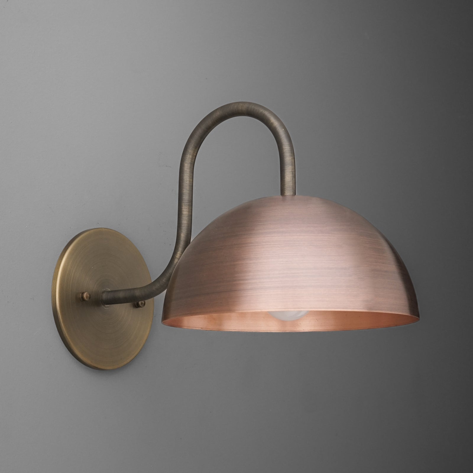 Wall-mounted sconce with brushed copper dome shade and curved dark bronze arm on round brass base. - SCONCE MODEL NO. 4008