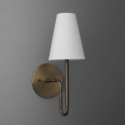 Wall sconce with a round antique brass base and a tall white fabric tapered lampshade. - SCONCE MODEL NO. 1007