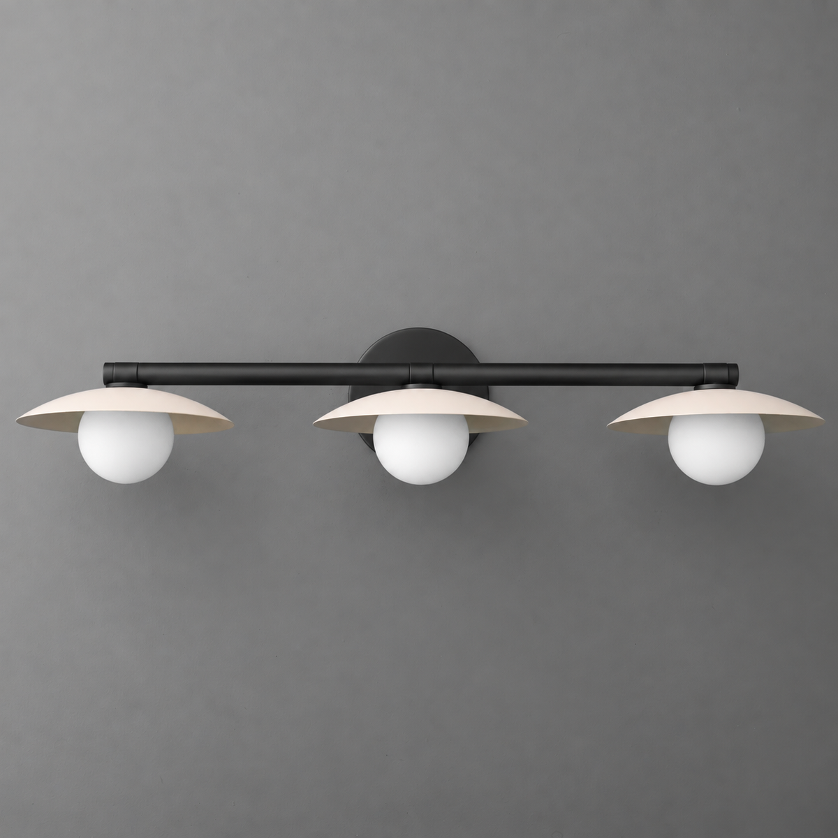 Black metal vanity light with three round white glass shades and flat disc-shaped metal accents. - VANITY LIGHT MODEL NO. 1156