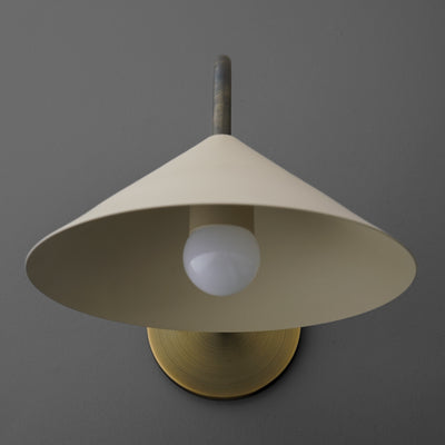 Cone-shaped cream metal sconce with exposed white bulb and brass circular wall mount. - SCONCE MODEL NO. 1015