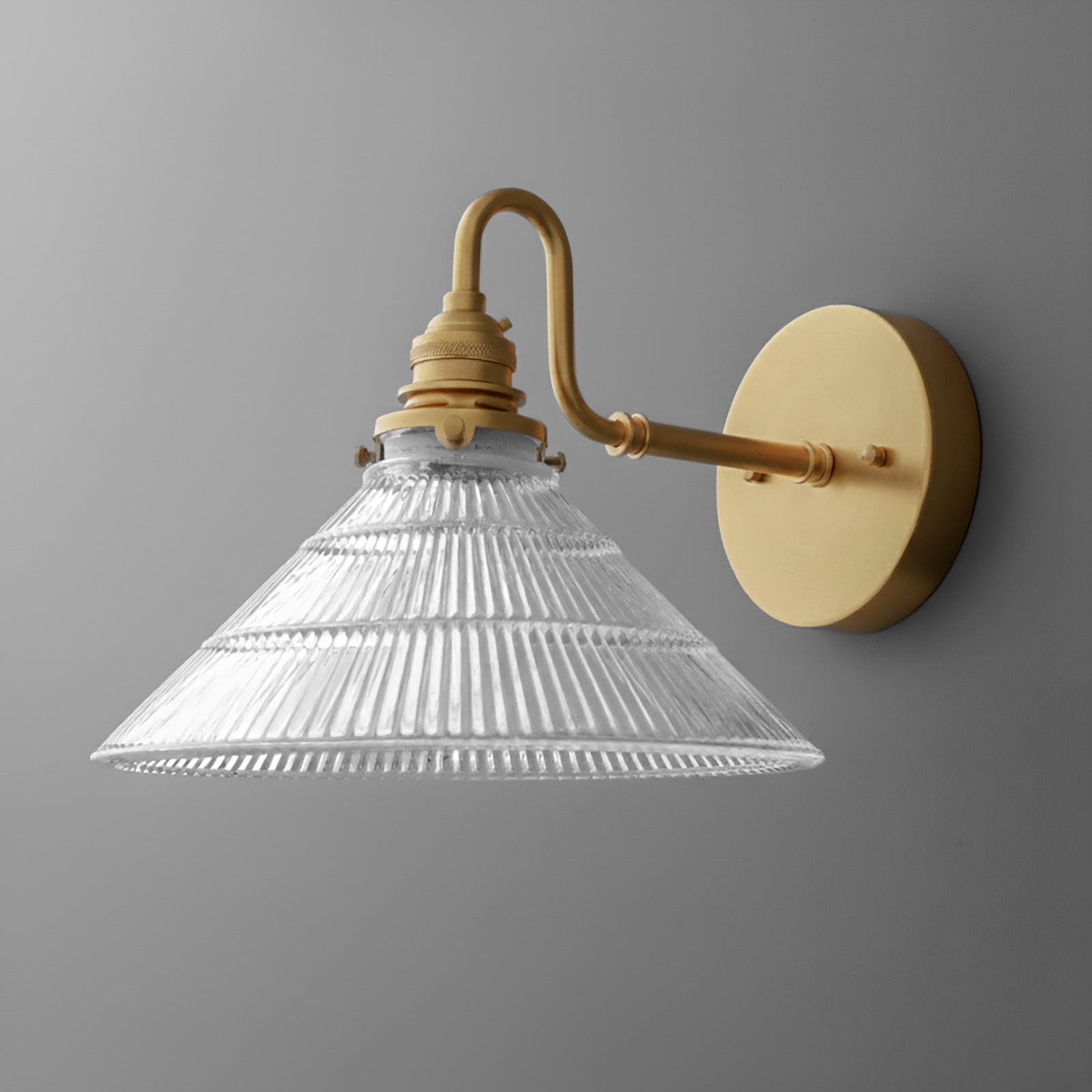 Gold metal wall sconce with clear ribbed glass conical shade and curved arm mounting on round base. - SCONCE MODEL NO. 4703