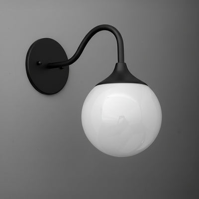 Black metal wall sconce with curved arm and round white glass globe shade. - SCONCE MODEL NO. 8734