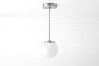 Mid-century modern pendant light with brushed nickel finish and white frosted glass globe shade. - PENDANT MODEL NO. 7056