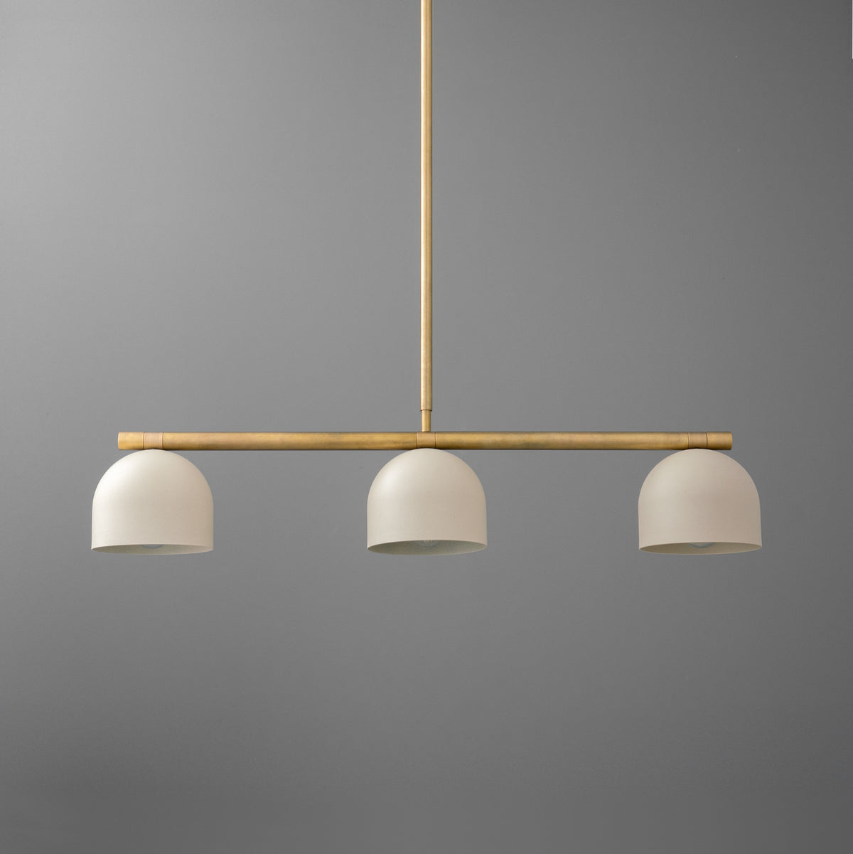 Brass chandelier with three white dome-shaped shades suspended from a horizontal rod. - CHANDELIER MODEL NO. 8477
