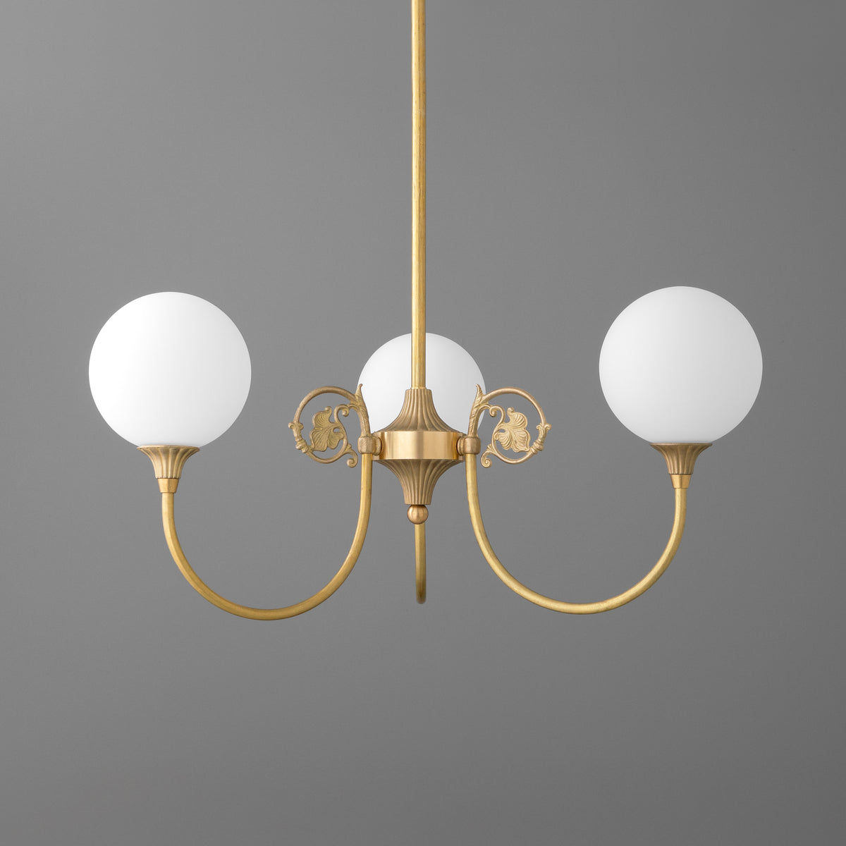 Three-light chandelier in Raw or Sealed Brass with scrolled arms and opal glass globe shades. - CHANDELIER MODEL NO. 0835