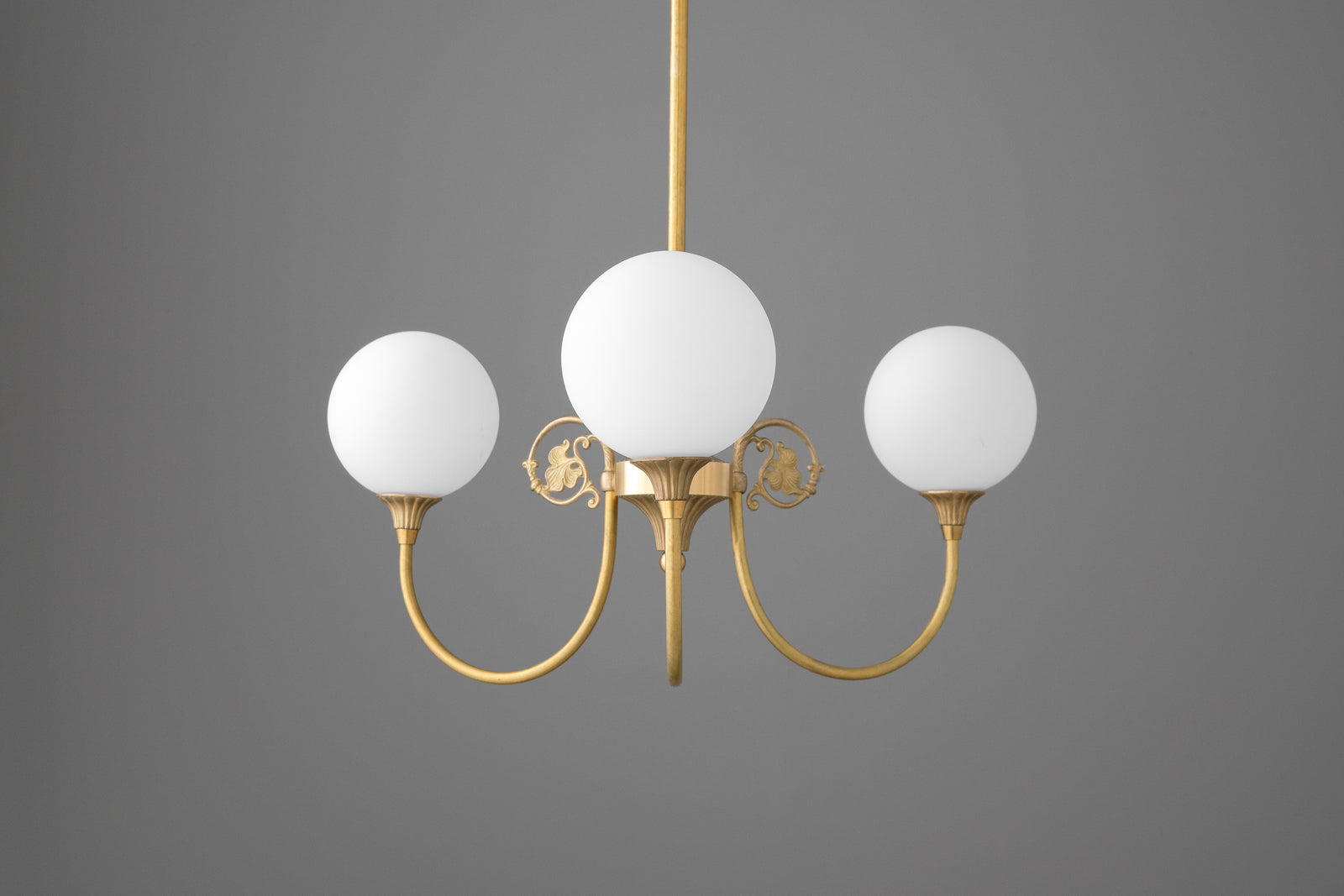 Three-light chandelier in Raw or Sealed Brass with curved arms, scrolled leaf ornaments and opal glass globe shades. - CHANDELIER MODEL NO. 0835