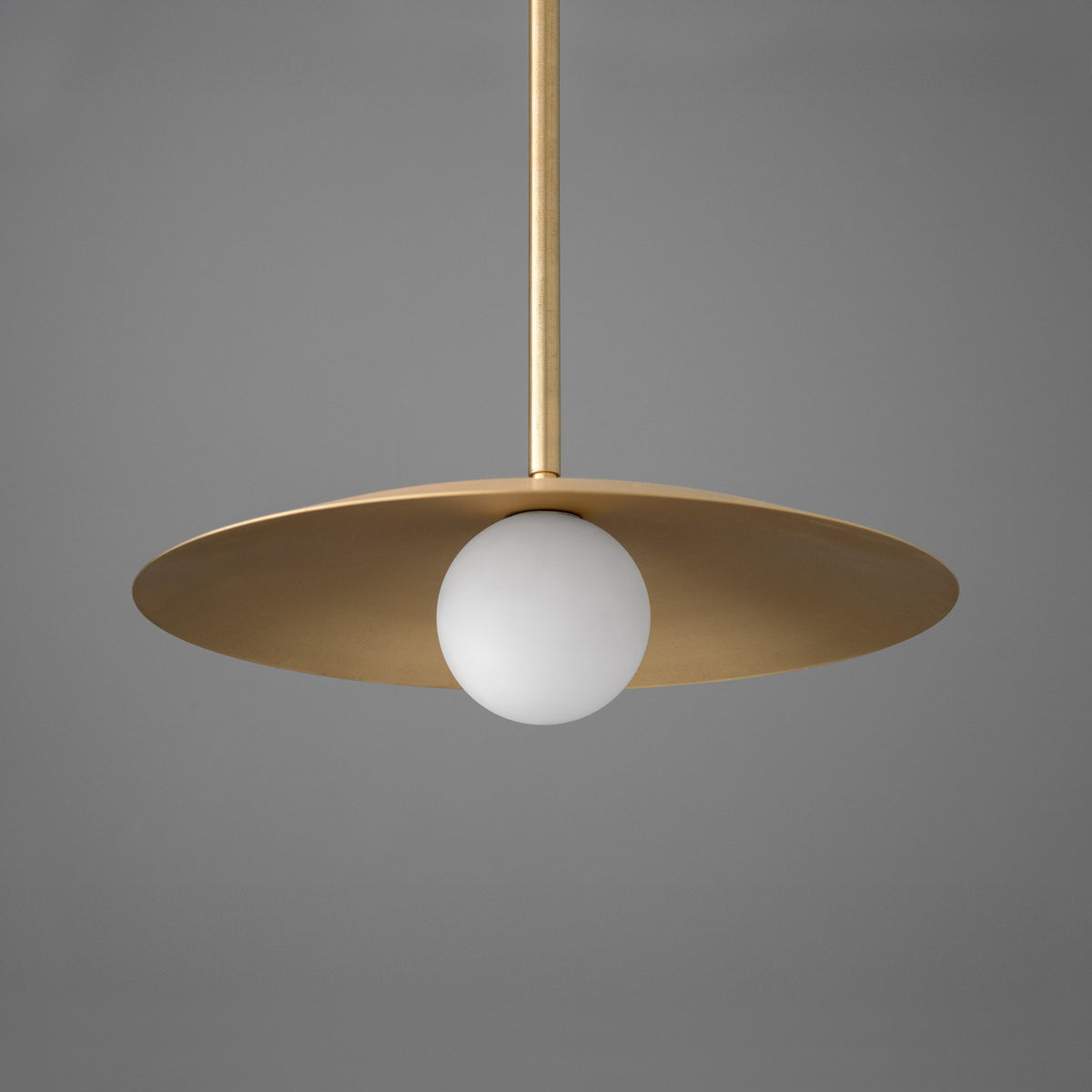 Pendant in Raw or Sealed Brass with a broad flat metal disc shade over an opal glass globe. - PENDANT MODEL NO. 7685
