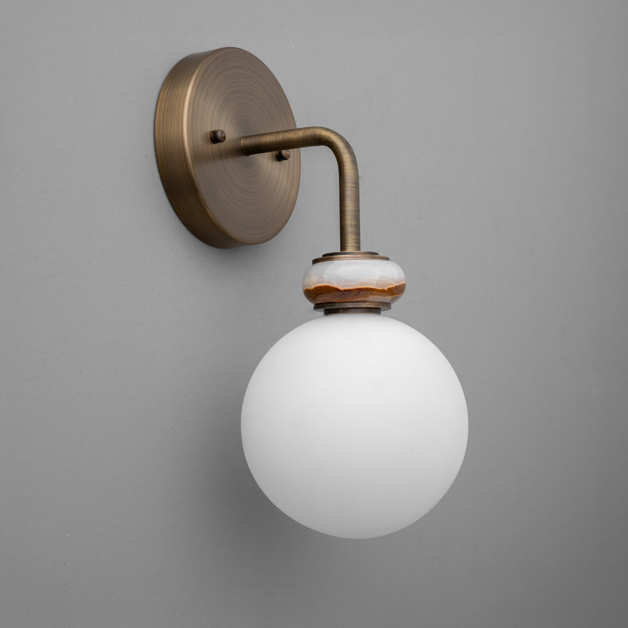 Minimalist wall sconce with antique brass finish and frosted white glass globe shade. - SCONCE MODEL NO. 5448