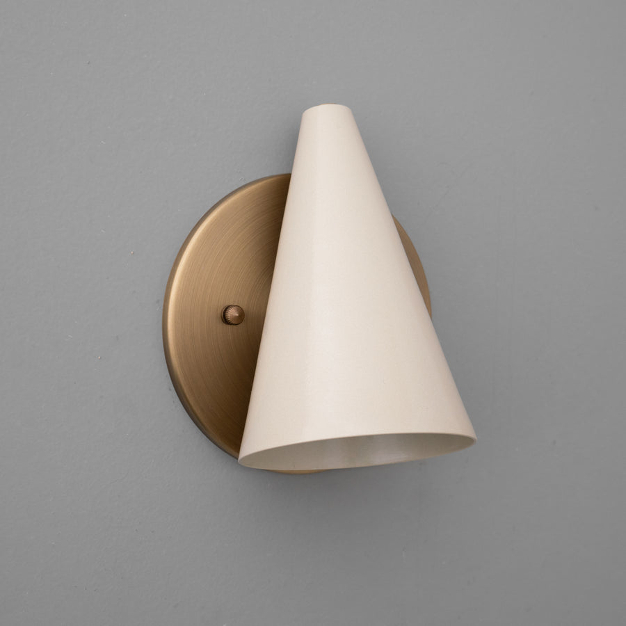 Antique brass wall sconce with cream tapered conical shade mounted on round backplate. - SCONCE MODEL NO. 5950