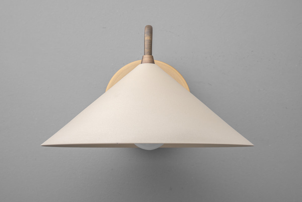 Wall sconce with wide cream fabric shade and antique brass mount against gray background. - SCONCE MODEL NO. 6528