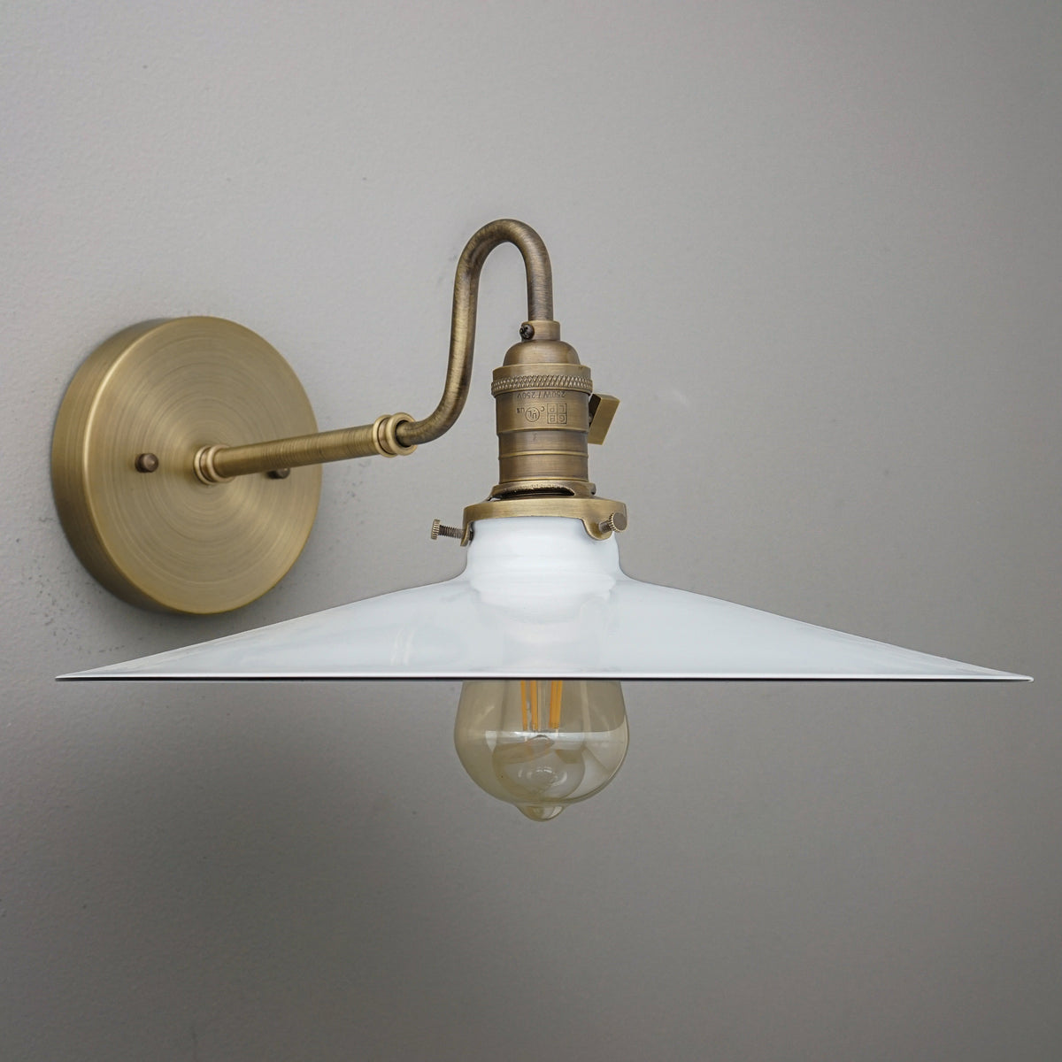 Wall-mounted sconce with antique brass finish and wide white conical metal shade, vintage exposed bulb. - SCONCE MODEL NO. 5562