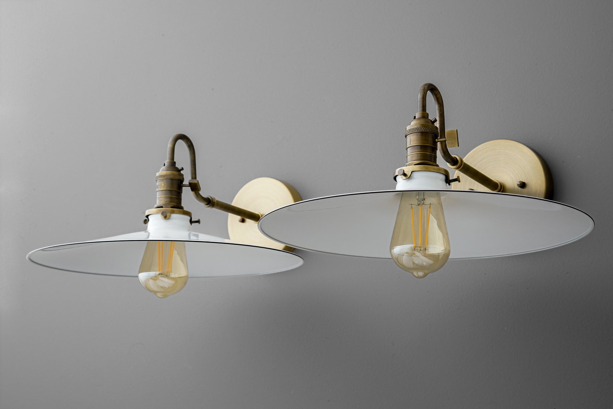 Antique brass wall sconce with large flat circular shade and exposed vintage filament bulbs. - SCONCE MODEL NO. 5562
