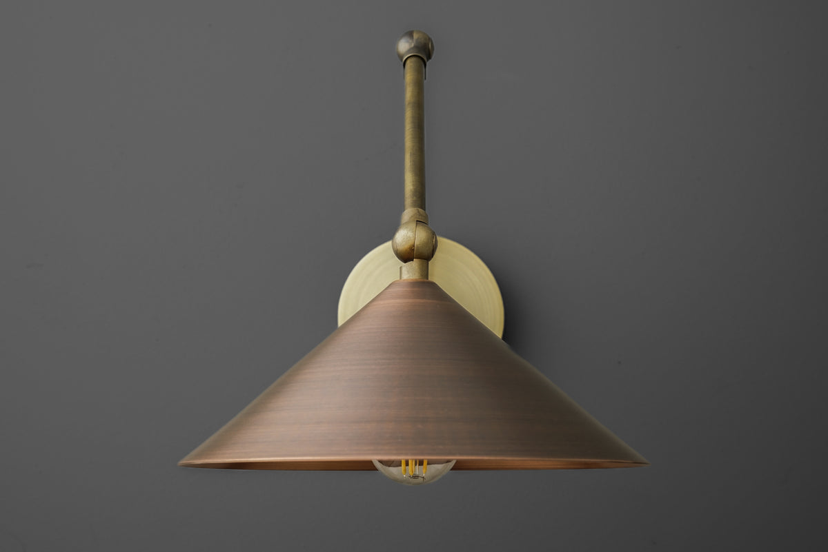 Wall sconce with wide conical shade in raw brass finish and exposed bulb detail. - SCONCE MODEL NO. 6414