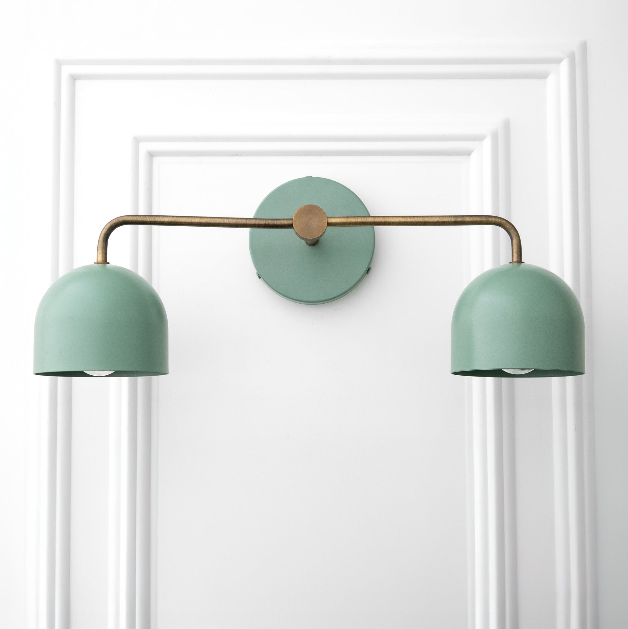 Scandinavian-style vanity light with two matte green dome shades and brushed brass horizontal arm. - VANITY LIGHT MODEL NO. 2082