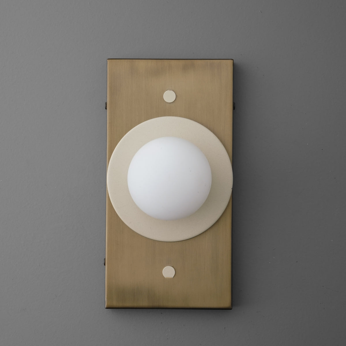 Antique brass rectangular wall sconce with cream circular backplate and white globe light. - SCONCE MODEL NO. 4474