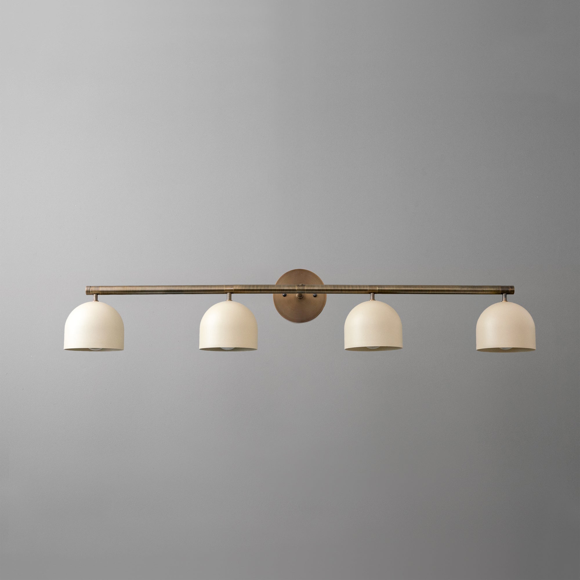 Four-light vanity fixture with antique brass finish and white dome shades on a horizontal bar. - VANITY MODEL NO. 6448