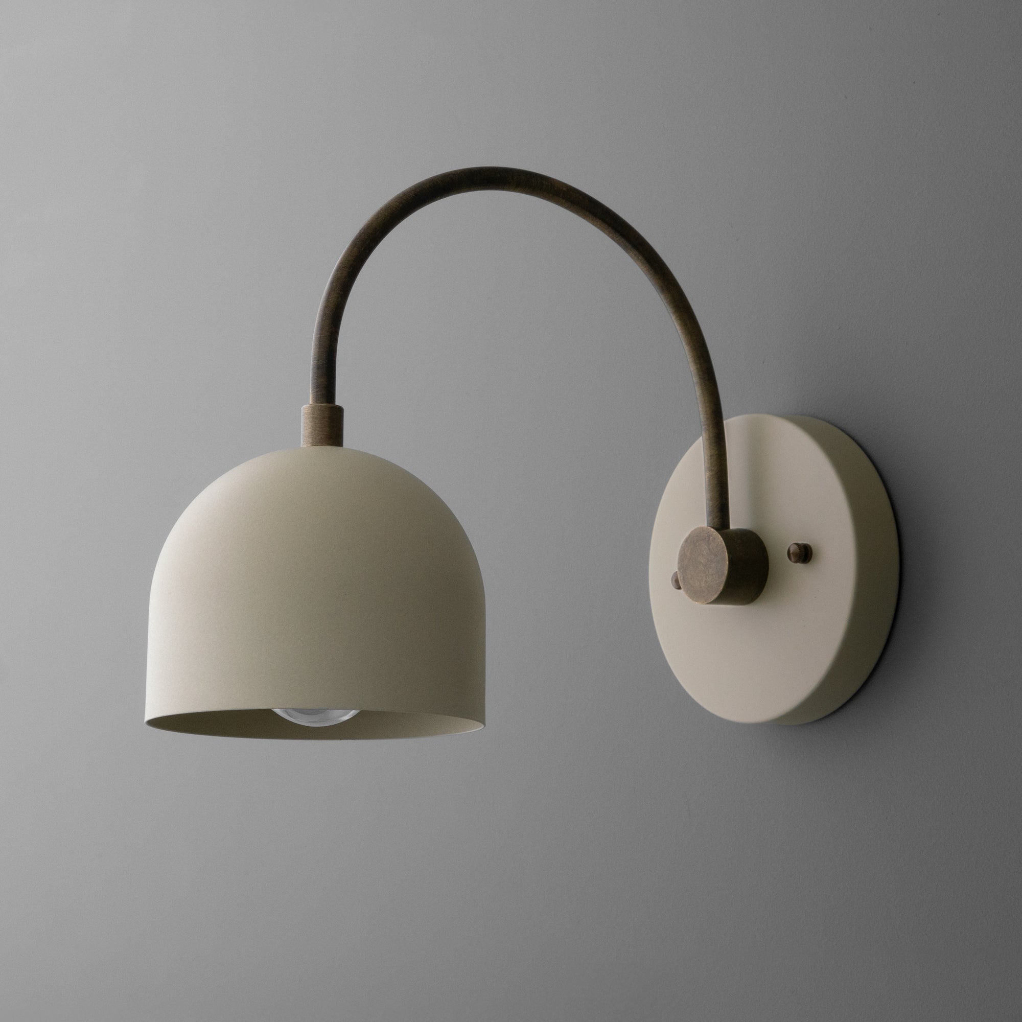 Matte beige semi-flush wall sconce with curved arm and dome-shaped metal shade in mid-century modern style. - SCONCE MODEL NO. 8586